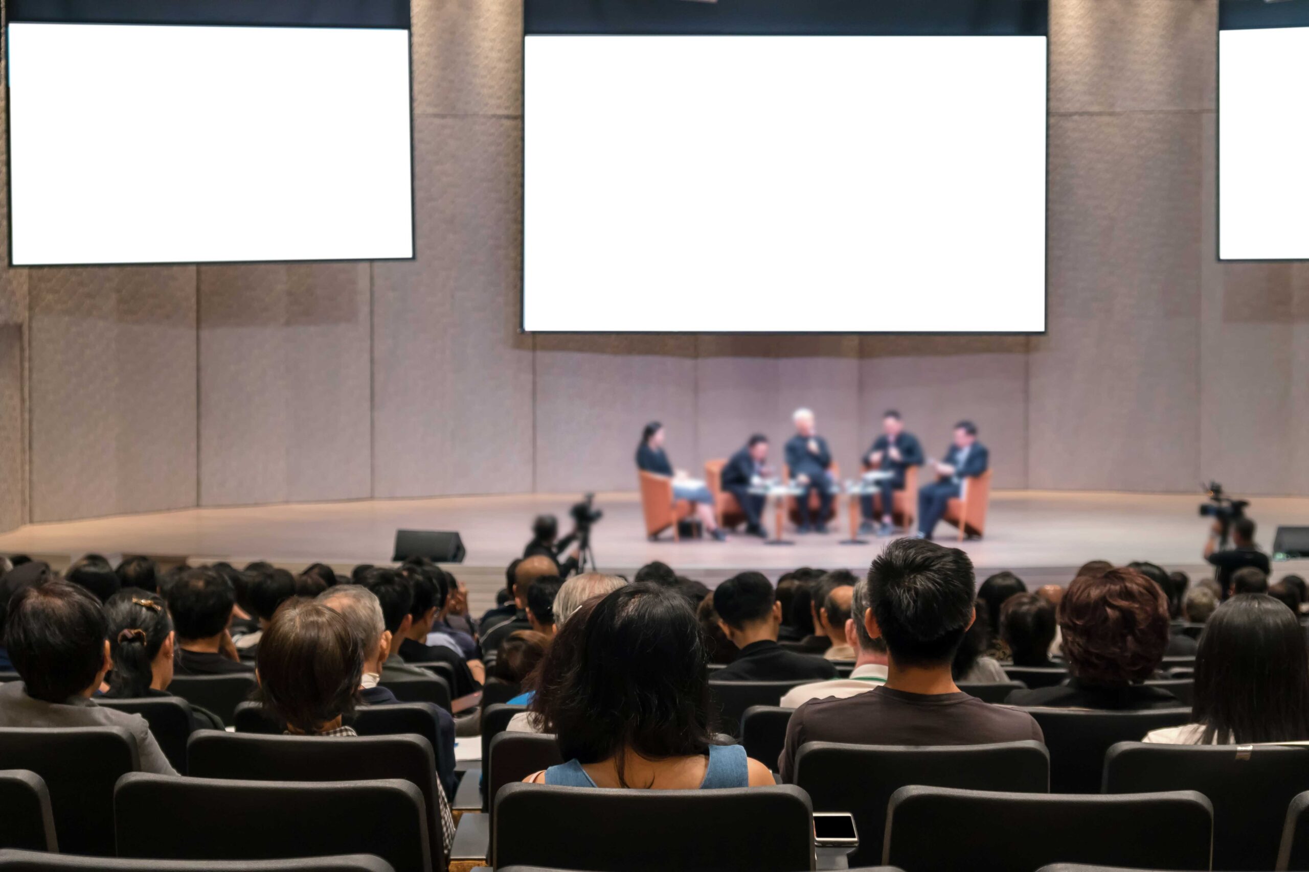 rear-view-of-audience-over-the-speakers-on-the-sta-2022-12-16-03-33-07-utc